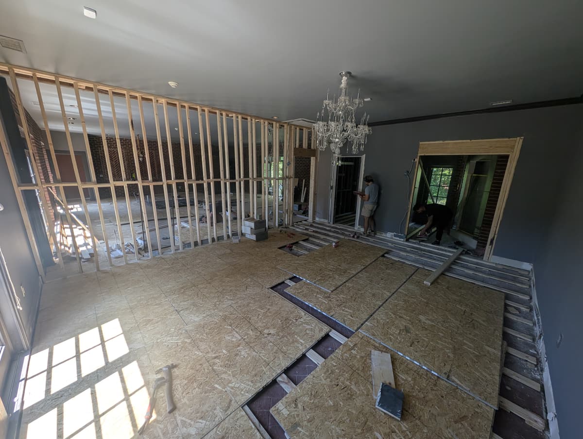 A large room with its new OSB subfloor laid down